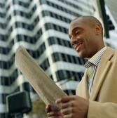 MAN READING NEWSPAPER